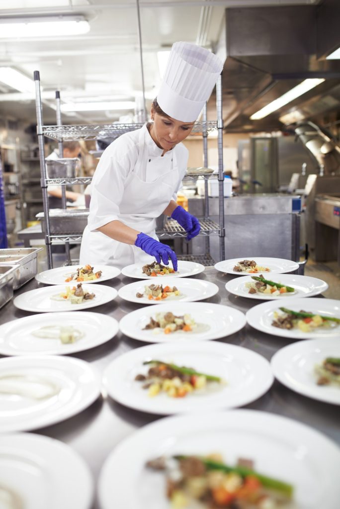 Shot of a chef plating food for a meal service in a professional kitchen